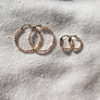 Megen Gabrielle Jewelry | huggie hoops. huggie earrings. minimal huggie earrings. huggie earrings with charms. 14k gold fill huggie earrings. CZ diamond huggies, diamond hoops, dot huggies, beaded hoop, beaded tiny hoop, tiny hoops, gold hoops, circle charm huggie earrings, circle dangle charm huggie earrings. 14k gold fill earrings. huggie hoop earrings, 14k gol