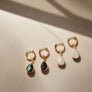 Megen Gabrielle Jewelry | Labradorite and Moonstone Huggie dangle earrings. huggie earrings. minimal huggie earrings. huggie earrings with charms. 14k gold fill huggie earrings. triangle charm huggie earrings, dagger huggie earrings. Leaf charm huggie earrings, petal charm huggie earrings. square charm huggie earrings, hammered square charm earrings. circle charm huggie earrings, circle dangle charm huggie earrings. 14k gold fill earrings. huggie hoop earrings, 14k gold fill huggie hoop earrings.