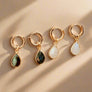 Megen Gabrielle Jewelry | Labradorite and Moonstone Huggie dangle earrings. huggie earrings. minimal huggie earrings. huggie earrings with charms. 14k gold fill huggie earrings. triangle charm huggie earrings, dagger huggie earrings. Leaf charm huggie earrings, petal charm huggie earrings. square charm huggie earrings, hammered square charm earrings. circle charm huggie earrings, circle dangle charm huggie earrings. 14k gold fill earrings. huggie hoop earrings, 14k gold fill huggie hoop earrings.