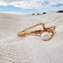 Megen Gabrielle Jewelry | 14k gold fill jewelry. 14k gold fill bangle, pearl bangle, pearl cuff, gold and pearl jewelry. Gold bangles, hammered bangle, handmade gold bangle. The handmade wave cuff bracelet. gold filled cuff bracelet, wave shaped.