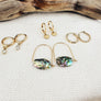 Megen Gabrielle Jewelry | huggie hoops. huggie earrings. minimal huggie earrings. huggie earrings with charms. 14k gold fill huggie earrings. CZ diamond huggies, diamond hoops, dot huggies, beaded hoop, beaded tiny hoop, tiny hoops, gold hoops, circle charm huggie earrings, circle dangle charm huggie earrings. 14k gold fill earrings. huggie hoop earrings, 14k gold fill huggie hoop earrings.
