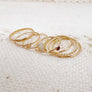 Megen Gabrielle Jewelry | The Whole Set, gold fill gemstone bands stack ring set. stack set with; one cove thick stacker, two thinner stackers, one beaded stacker, and three gemstone rings. Details; This 14K Gold- Fill Stacking Ring Set includes: One 4x6mm oval opal ring, one 3mm round pink tourmaline ring, one 3mm round opal ring, one thick band stacker, two thinner band stackers, and one beaded stacker. All rings gently hammered for texture and extra shine.
