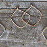 Megen Gabrielle Jewelry | Geometric diamond shaped hoop earrings. diamond shaped hoop earrings. 14k gold fill hoop earrings, 14k rose gold fill earrings, sterling silver earrings. geometric gold earrings, geometric silver earrings, geometric rose gold earrings. minimalist geometric earrings. geometric gold earrings hoop. geometric hoops gold. diamond shaped earrings. silver diamond shaped earrings. rhombus shaped earrings. diamond earrings.