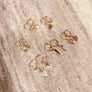 Megen Gabrielle Jewelry | Huggie dangle earrings. huggie earrings. minimal huggie earrings. huggie earrings with charms. 14k gold fill huggie earrings. triangle charm huggie earrings, dagger huggie earrings. Leaf charm huggie earrings, petal charm huggie earrings. square charm huggie earrings, hammered square charm earrings. circle charm huggie earrings, curcle dangle charm huggie earrings. 14k gold fill earrings. huggie hoop earrings, 14k gold fill huggie hoop earrings.