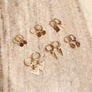 Megen Gabrielle Jewelry | Huggie dangle earrings. huggie earrings. minimal huggie earrings. huggie earrings with charms. 14k gold fill huggie earrings. triangle charm huggie earrings, dagger huggie earrings. Leaf charm huggie earrings, petal charm huggie earrings. square charm huggie earrings, hammered square charm earrings. circle charm huggie earrings, curcle dangle charm huggie earrings. 14k gold fill earrings. huggie hoop earrings, 14k gold fill huggie hoop earrings.