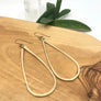Megen Gabrielle Jewelry | Tear drop hoop earrings in 14k gold filled. Handmade and hammered for texture.