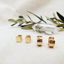Megen Gabrielle Jewelry | 18K gold filled huggie earrings. huggie hoop earrings. simple huggie earrings. everyday earrings. Gold filled huggie earrings. circle huggie earings, square huggie earrings. comfortable earrings, every day wear.