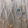 Megen Gabrielle Jewelry | teardrop-shaped hoop with gold disk drop and another pair of hoops wire wrapped with a chrysocolla stone and has a little circle drop as-well.