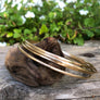 Megen Gabrielle Jewelry | 14K gold filled solid bangle. Hammered for texture and shine. Classic gold bangle.