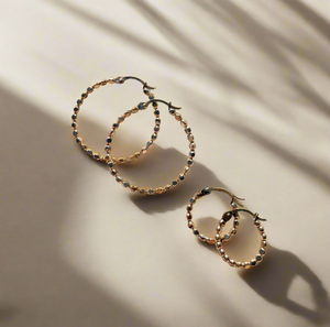 Megen Gabrielle Jewelry | huggie hoops. huggie earrings. minimal huggie earrings. huggie earrings with charms. 14k gold fill huggie earrings. CZ diamond huggies, diamond hoops, dot huggies, beaded hoop, beaded tiny hoop, tiny hoops, gold hoops, circle charm huggie earrings, circle dangle charm huggie earrings. 14k gold fill earrings. huggie hoop earrings, 14k gol
