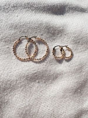 Megen Gabrielle Jewelry | huggie hoops. huggie earrings. minimal huggie earrings. huggie earrings with charms. 14k gold fill huggie earrings. CZ diamond huggies, diamond hoops, dot huggies, beaded hoop, beaded tiny hoop, tiny hoops, gold hoops, circle charm huggie earrings, circle dangle charm huggie earrings. 14k gold fill earrings. huggie hoop earrings, 14k gol
