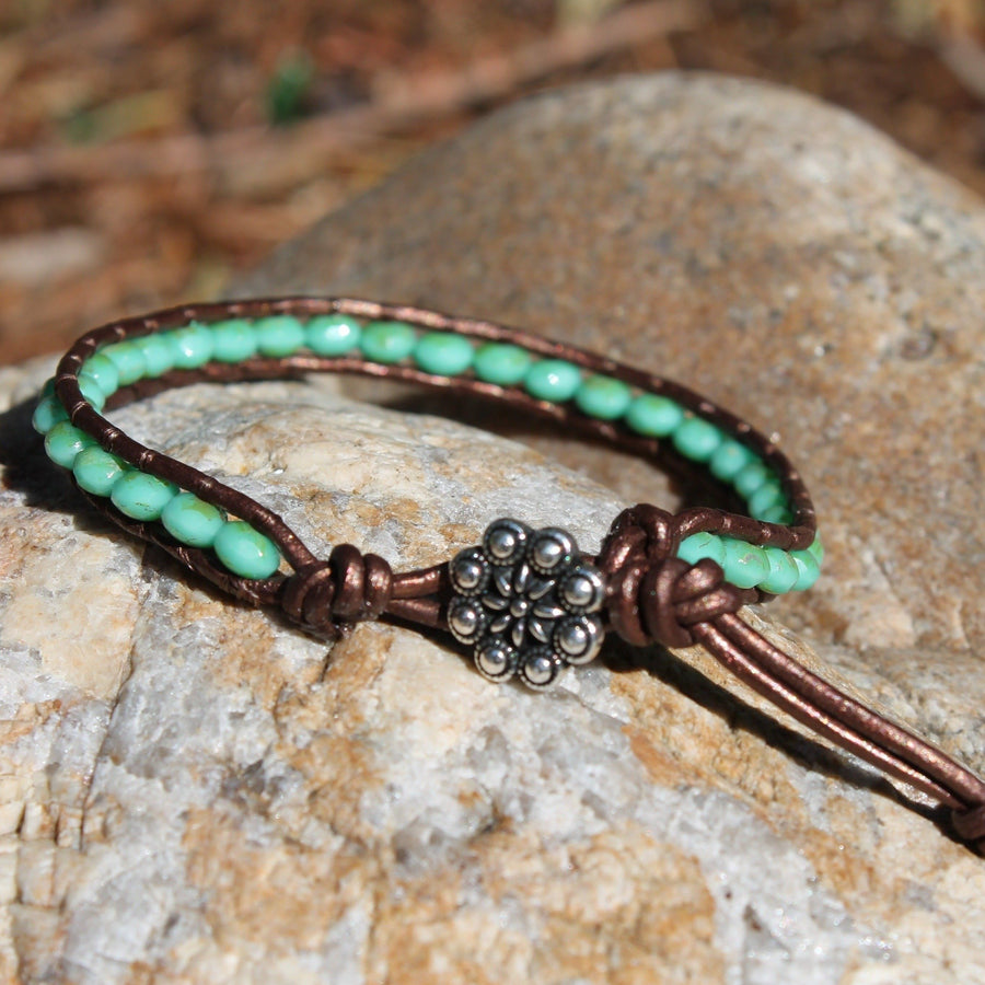 Single layer beaded wrap bracelet with turquoise beads and silver button closure 