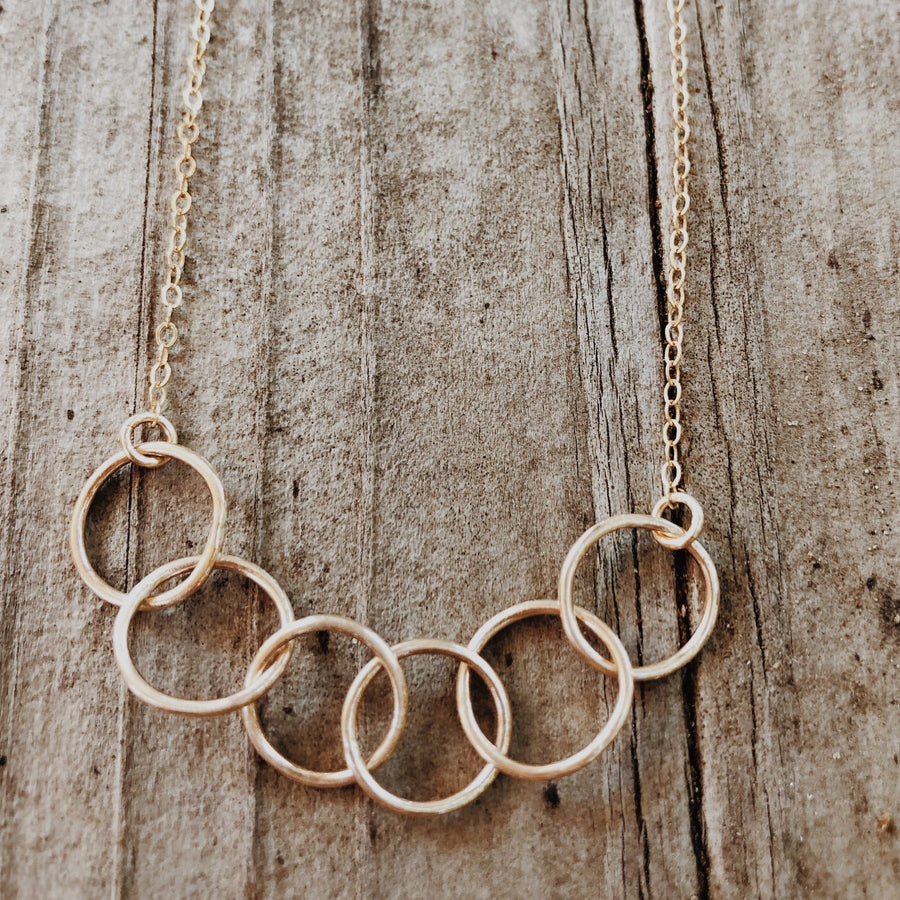 Megen Gabrielle Jewelry | circles necklace, chain and pendaendt circle necklace. 14k gold fill necklace. gold necklace. family necklace. loved ones necklace. necklace. significant other necklace