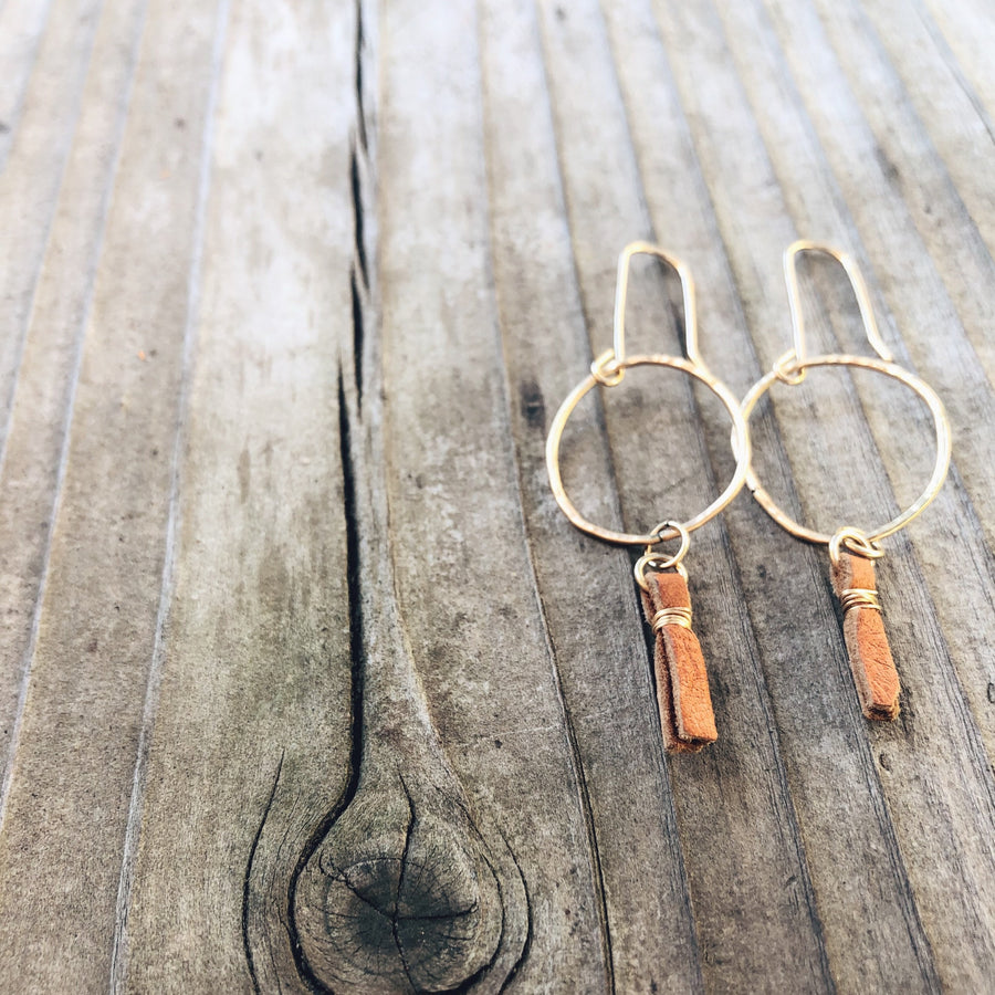 Megen Gabrielle Jewelry | handmade circle hoops with small leather tassel. Small hoop earrings. Earrings with leather. Hoop earrings with leather